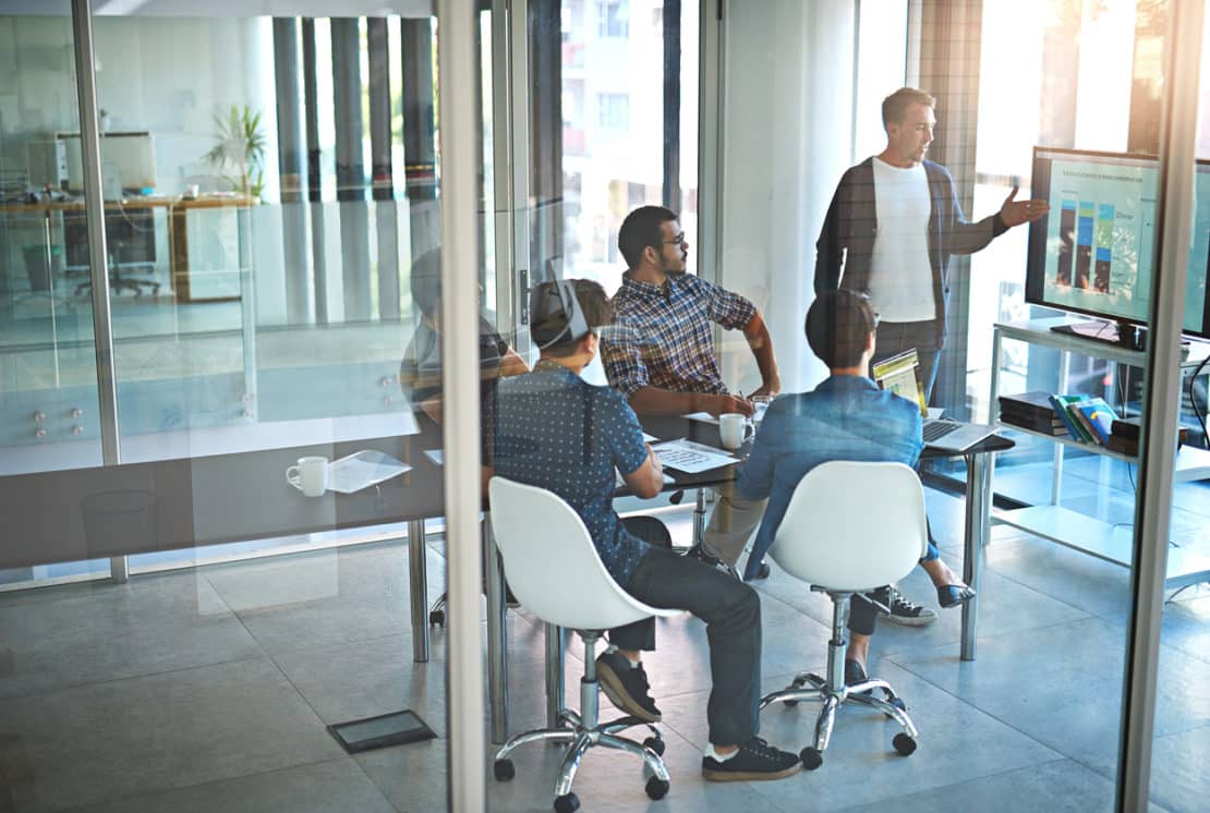 man presenting to his team in meeting