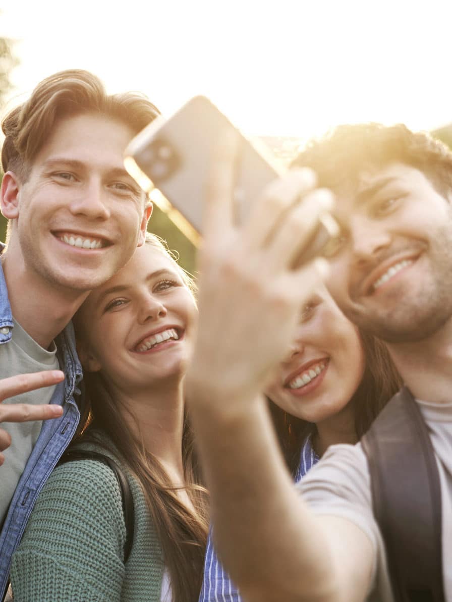 Group of caucasian students taking selfie outside the university campus