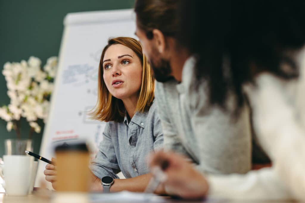 Young businesswoman having a discussion with her colleagues in a boardroom