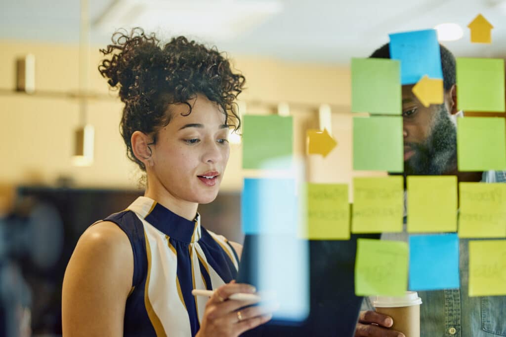 woman stood in front of board with notes