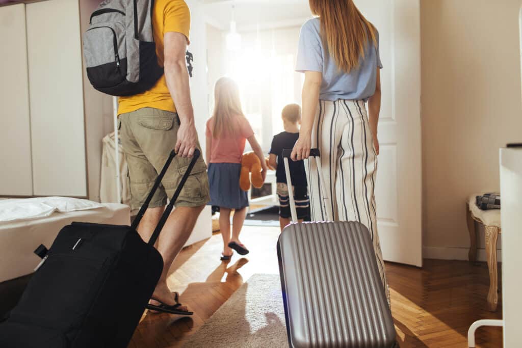 shot of family leaving for a holiday with suitcases